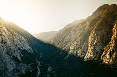 During the day, under the sky of the white mountains with green and brown
